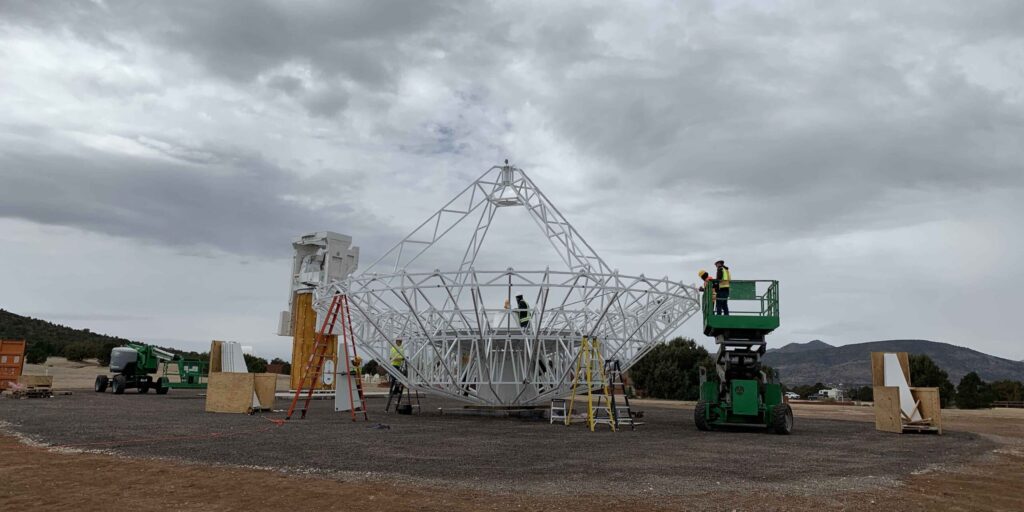 Construction and assembly of VLBI antenna tower and closer view of the antenna. 